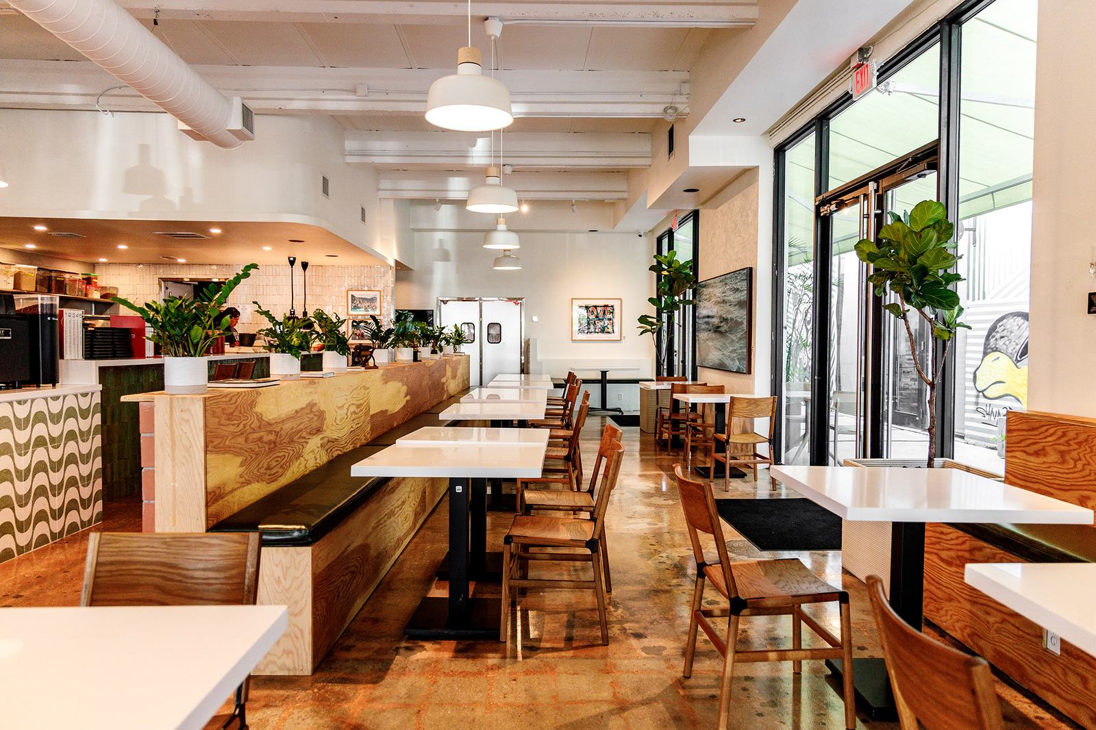 Our bright, modern café interior with a pizza oven and a wavy tiled counter.